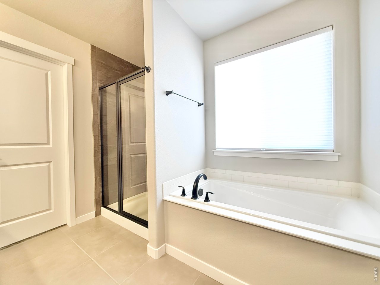 1215 5th Street Pierce, CO 80650 - Photo 11 of 22 a bathroom with a bathtub and a shower