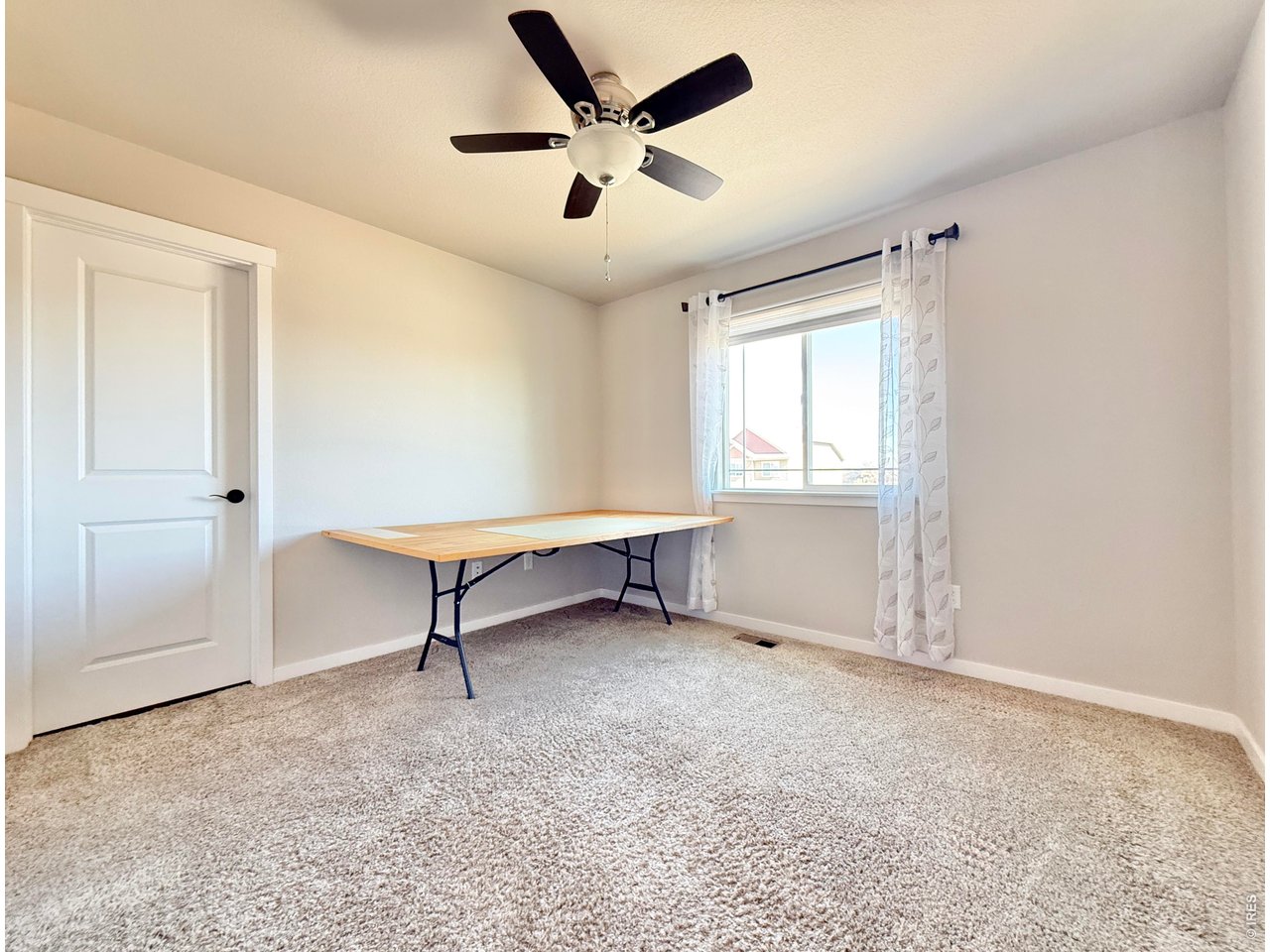 1215 5th Street Pierce, CO 80650 - Photo 14 of 22 a view of an empty room with a window