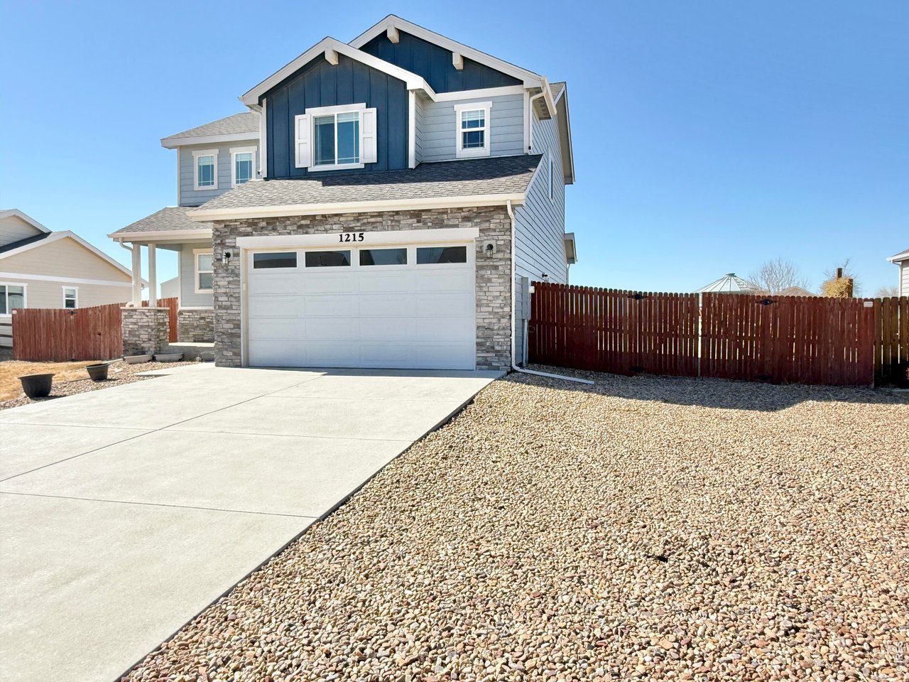 1215 5th Street Pierce, CO 80650 - Photo 2 of 22 a front view of a house with a yard