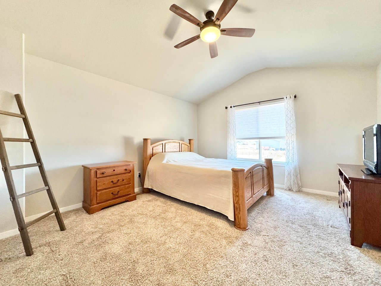 1215 5th Street Pierce, CO 80650 - Photo 9 of 22 a bedroom with a bed dresser and a window