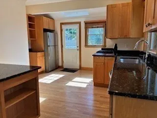 a kitchen with stainless steel appliances granite countertop a refrigerator and a stove
