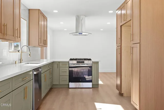 a kitchen with stainless steel appliances granite countertop a sink stove and refrigerator