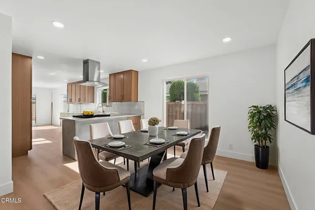 a view of a dining room with furniture and a potted plant
