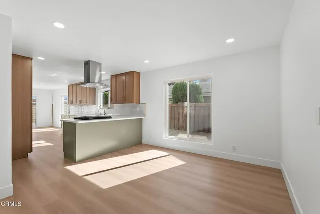 a view of open kitchen with granite countertop cabinets
