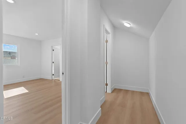 a view of a room with wooden floor