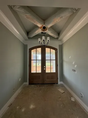 an empty room with a ceiling fan and window