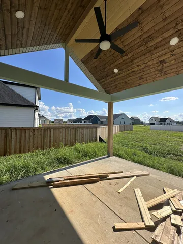 a view of a backyard with table and chairs