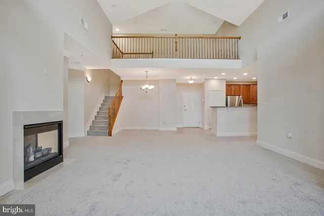 en empty room with windows and fireplace