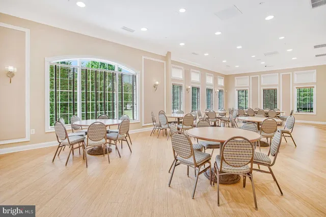 a dining room with furniture and wooden floor