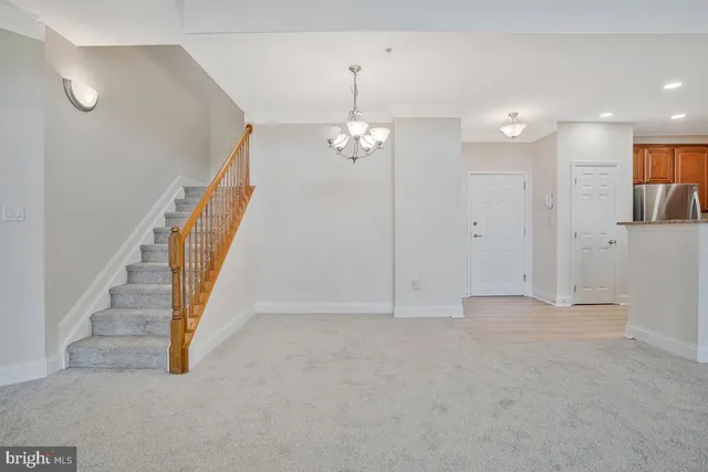 en view interior of a house with stairs and a chandelier fan