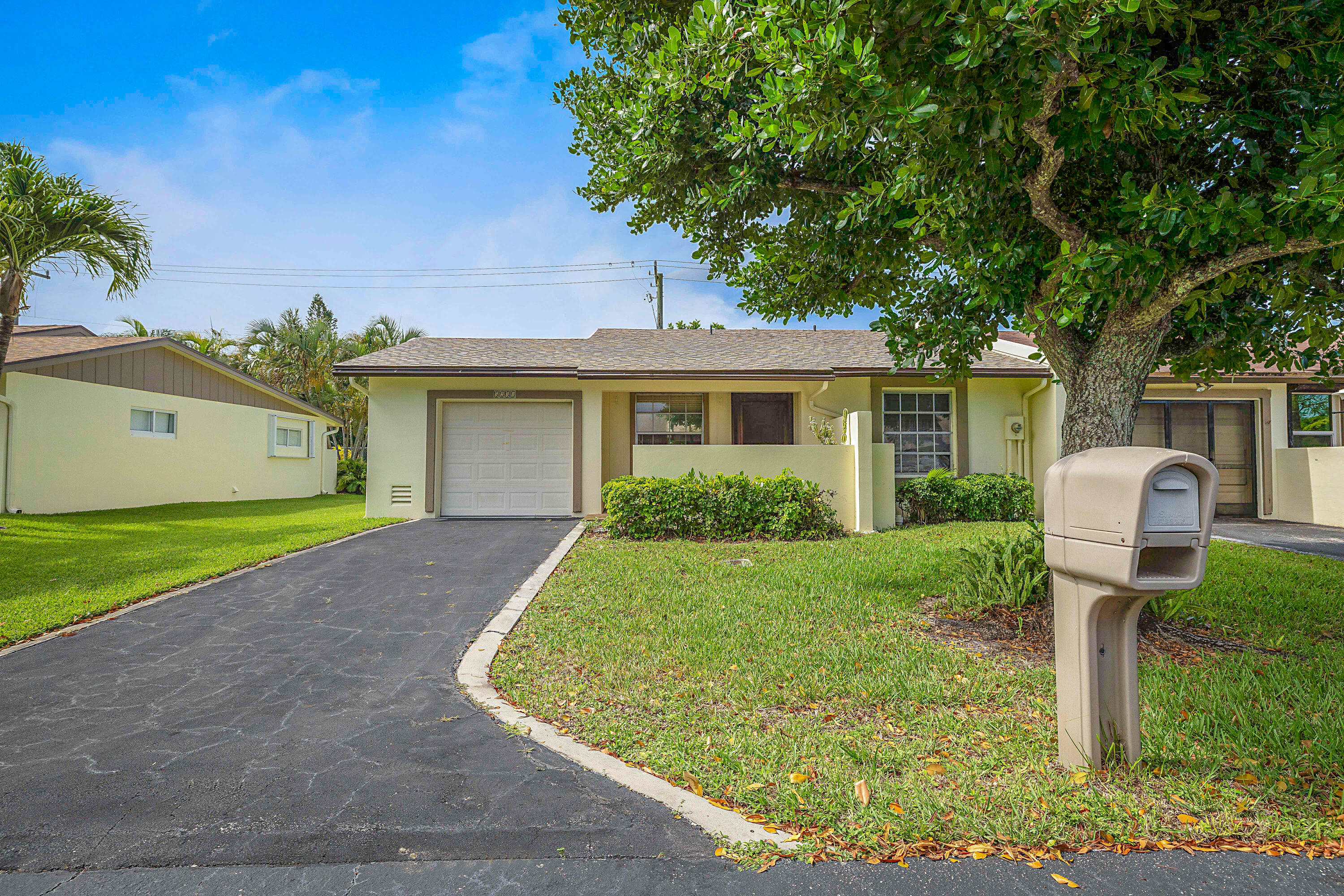 5231 Copperleaf Circle Delray Beach, FL 33484 - Photo 30 of 31 a front view of a house with garden