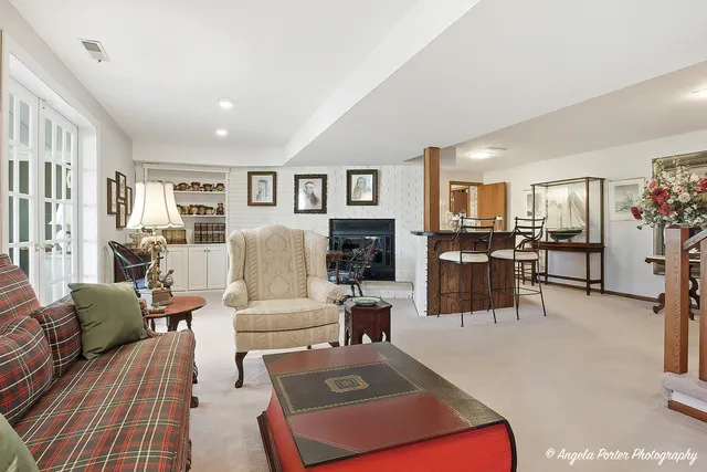 a living room with furniture and a floor to ceiling window