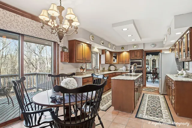 a dining room with furniture a chandelier and wooden floor