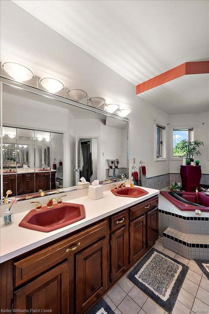 69069 Campground Road Romeo, MI 48065 - Photo 46 of 78 Bathroom featuring a dual vanity with dark wood cabinetry and a large mirror