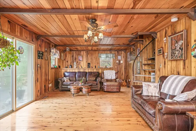 a living room with furniture and a chandelier