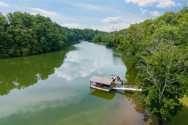 an aerial view of a house with outdoor space swimming pool and lake view