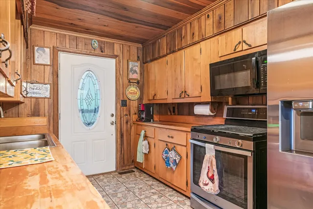 a kitchen with stainless steel appliances granite countertop a stove and a microwave