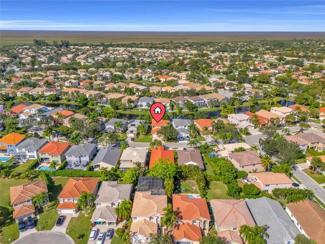 an aerial view of residential houses with outdoor space