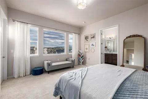 a bedroom with a bed couch and window