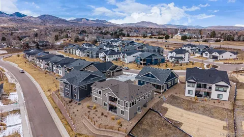 an aerial view of a house with a mountain