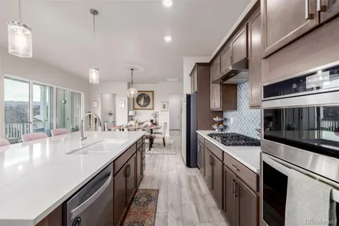 a kitchen with stainless steel appliances a sink stove and cabinets
