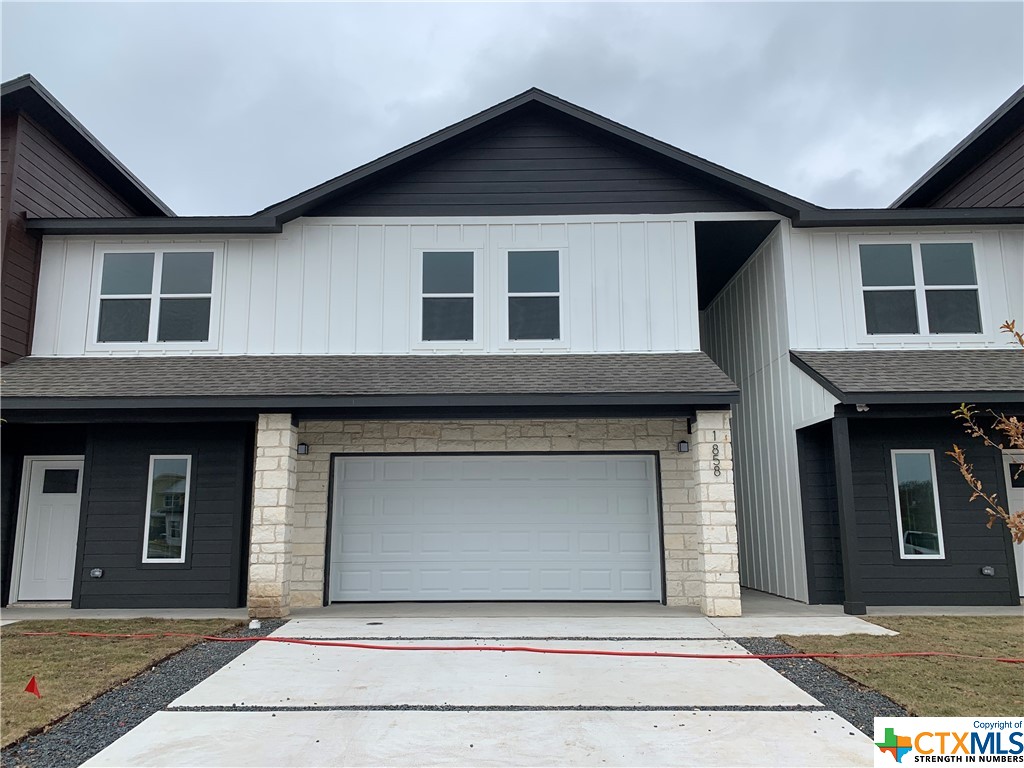 a front view of a house with garage