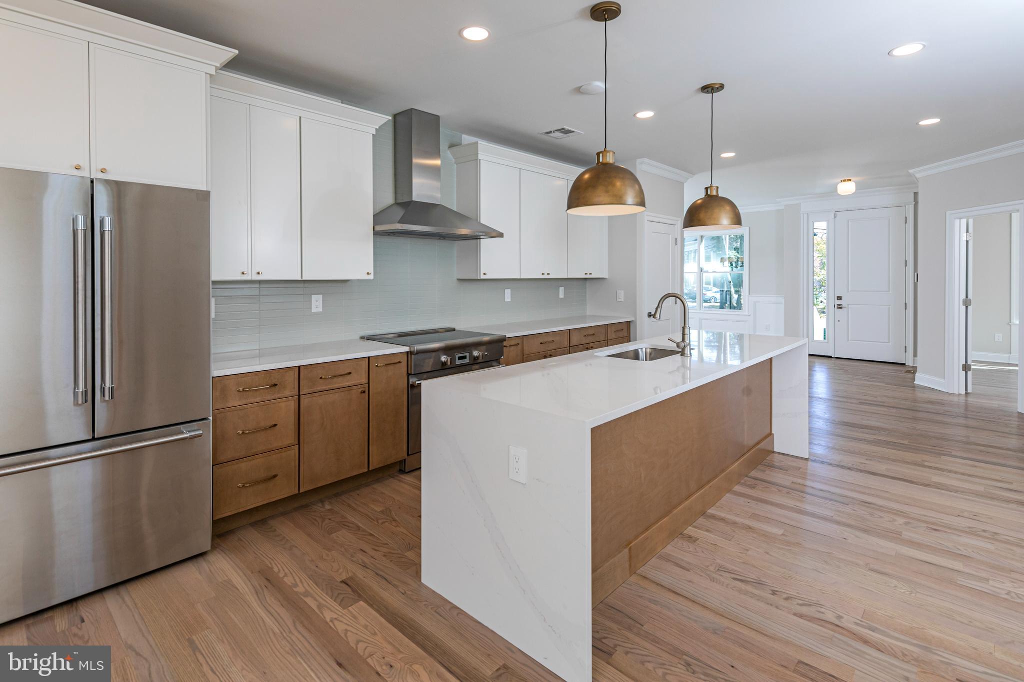 576 Ewing Street Princeton, NJ 08540 - Photo 11 of 61 a kitchen with stainless steel appliances granite countertop a sink a stove a refrigerator and island with wooden floor