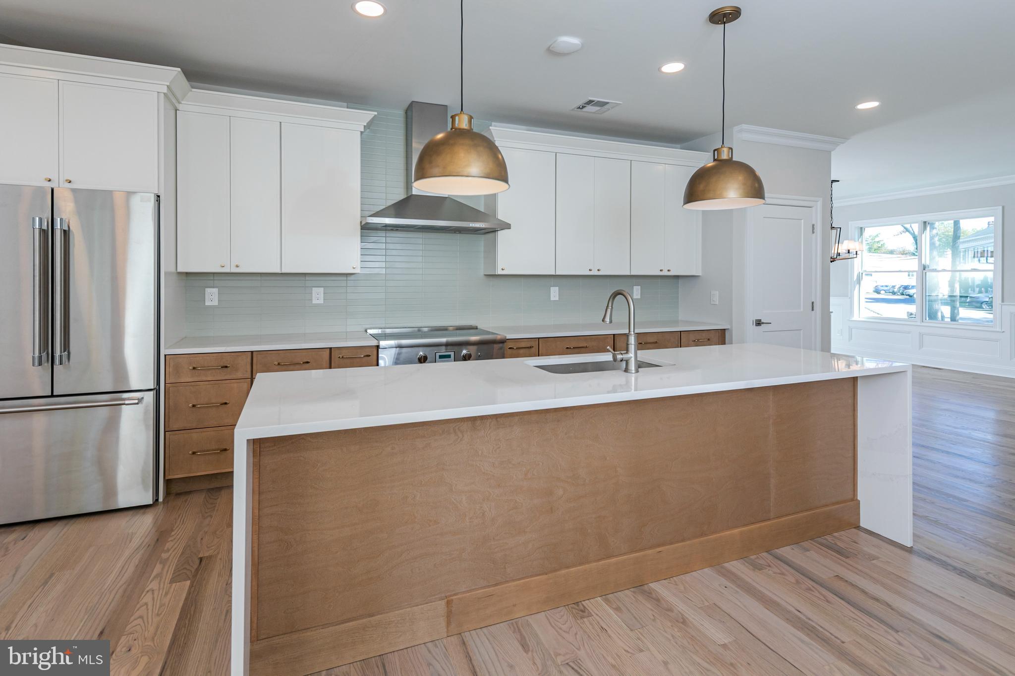 576 Ewing Street Princeton, NJ 08540 - Photo 12 of 61 a kitchen with stainless steel appliances granite countertop a sink a stove a refrigerator and island with wooden floor