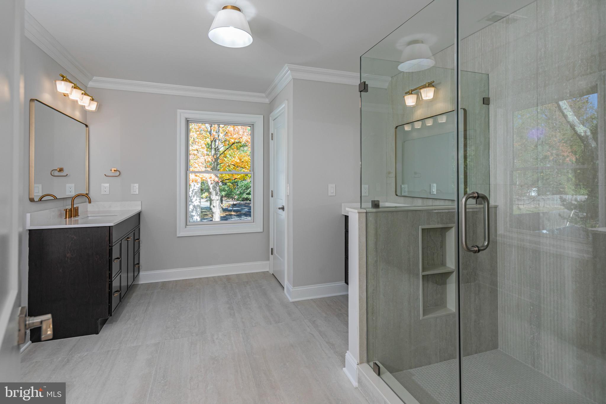 576 Ewing Street Princeton, NJ 08540 - Photo 35 of 61 a bathroom with a double vanity sink a mirror and a shower