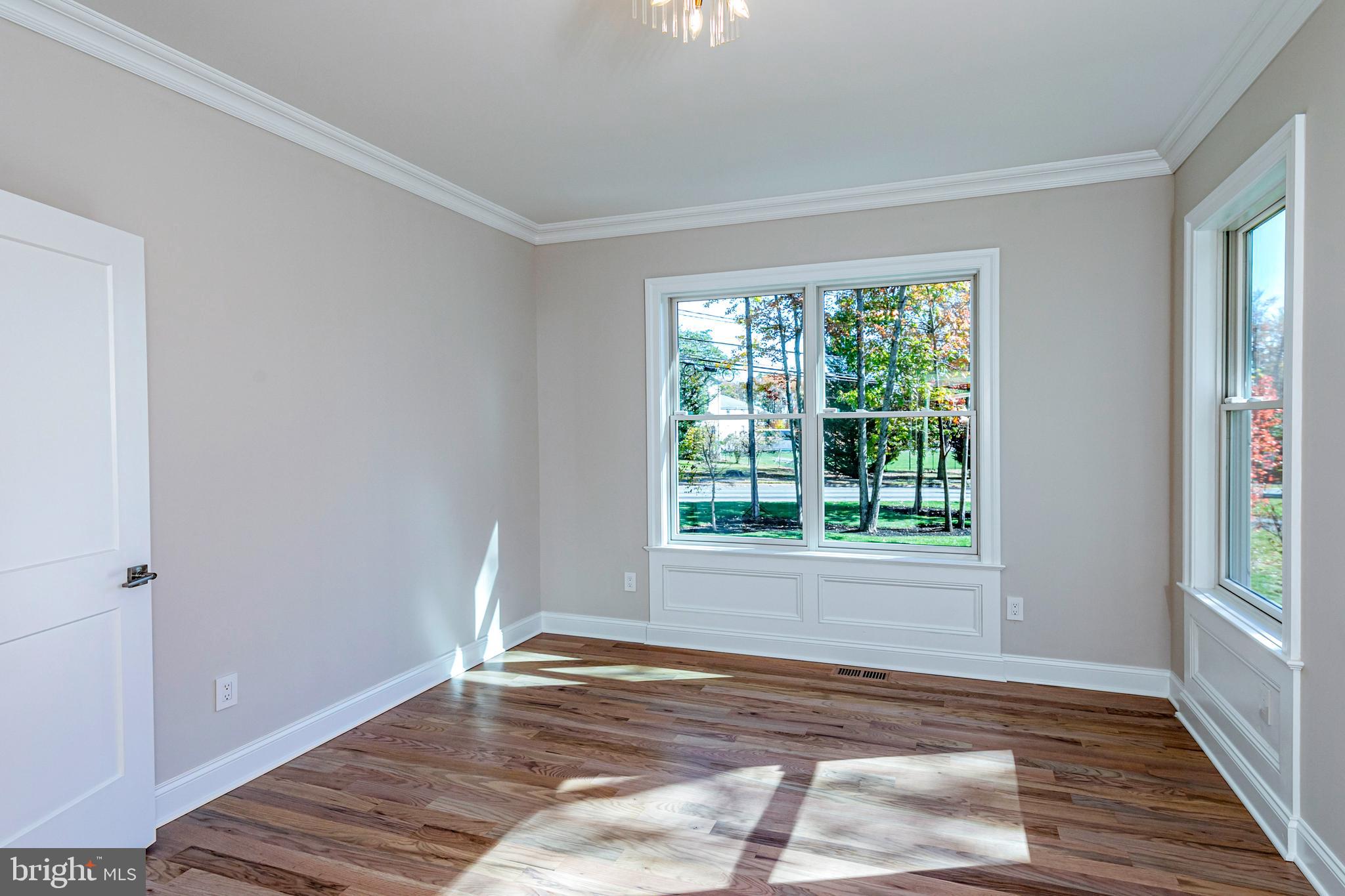 576 Ewing Street Princeton, NJ 08540 - Photo 6 of 61 a view of an empty room with wooden floor and a window