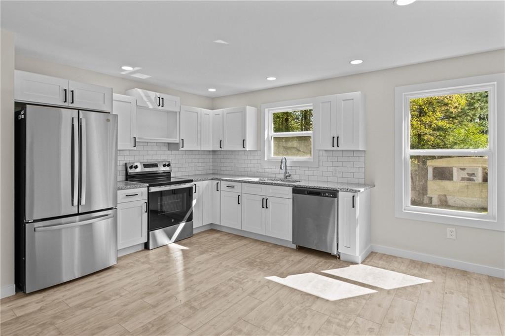 94 Orchard Road Summerville, GA 30747 - Photo 3 of 11 a kitchen with a refrigerator and a sink