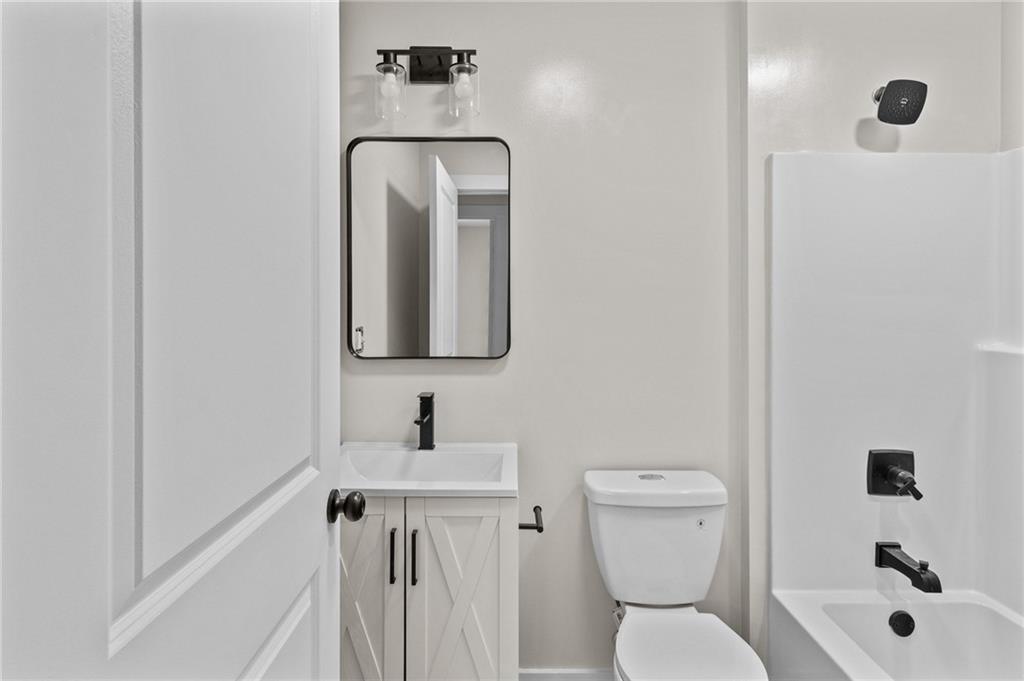 94 Orchard Road Summerville, GA 30747 - Photo 8 of 11 a bathroom with a toilet sink and mirror