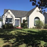 a view of a house with backyard and garden