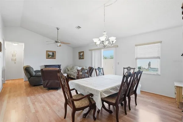 a view of a dining room with furniture and a potted plant