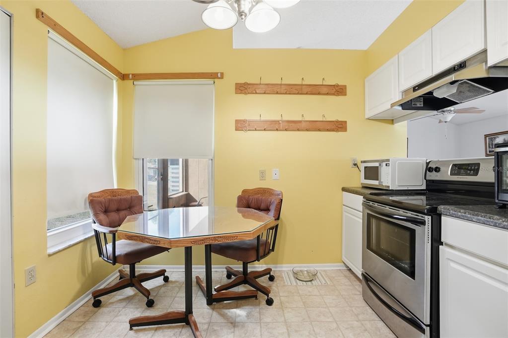3280 Ambassador Avenue Spring Hill, FL 34609 - Photo 14 of 36 a view of a dining room with furniture and a potted plant