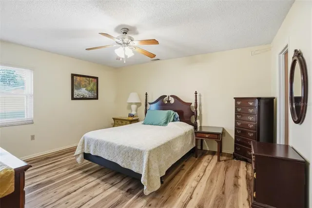 a bedroom with a bed and a flat tv screen on dresser