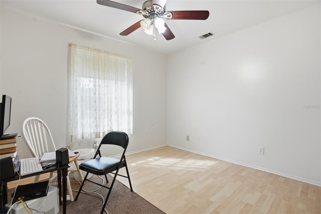 3280 Ambassador Avenue Spring Hill, FL 34609 - Photo 18 of 36 a view of a workspace with furniture and a window