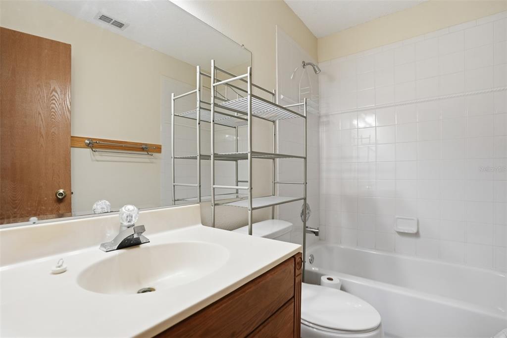 3280 Ambassador Avenue Spring Hill, FL 34609 - Photo 23 of 36 a bathroom with a sink toilet vanity and shower