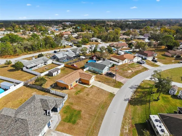 an aerial view of residential houses with outdoor space