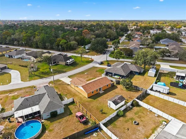 an aerial view of residential houses with outdoor space