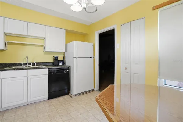 a kitchen with a sink a refrigerator and a stove