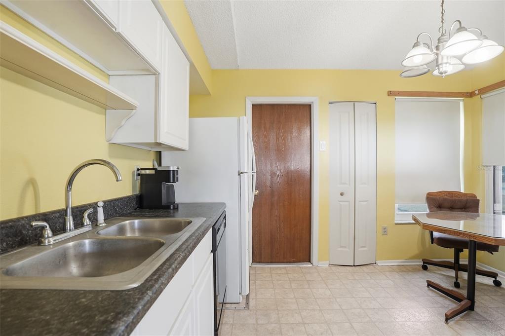 3280 Ambassador Avenue Spring Hill, FL 34609 - Photo 10 of 36 a kitchen with kitchen island a sink and a refrigerator