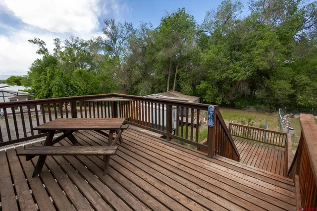 a view of balcony with wooden floor and fence