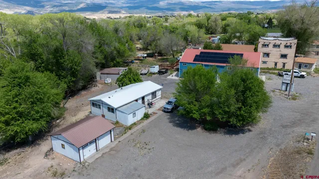 an aerial view of a house with a yard and lake view