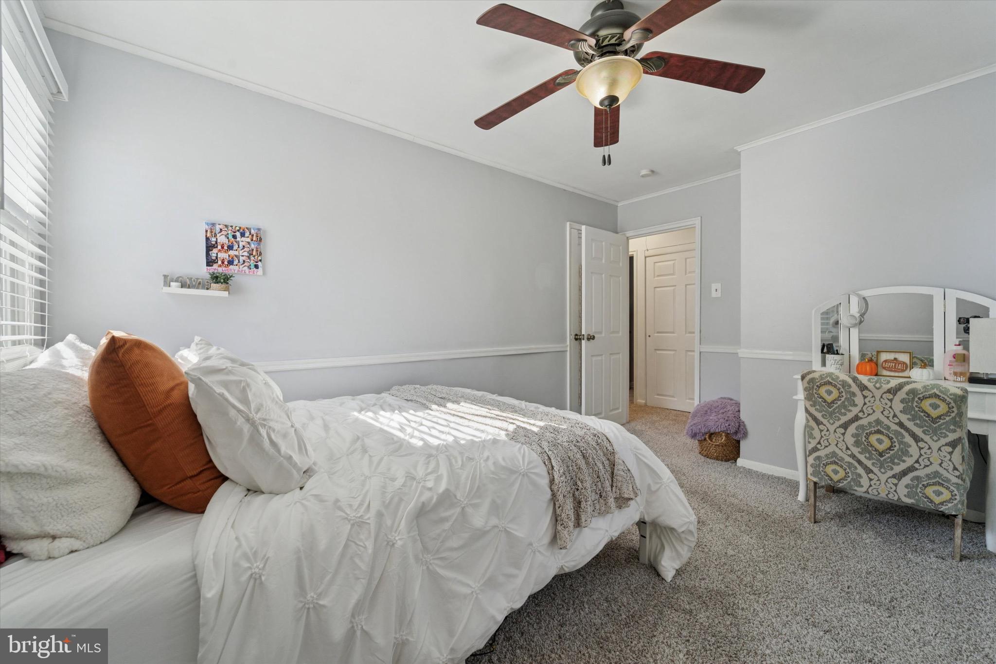 720 Swarthmorewood Lane Swarthmore, PA 19081 - Photo 11 of 25 a bedroom with a bed and a chandelier