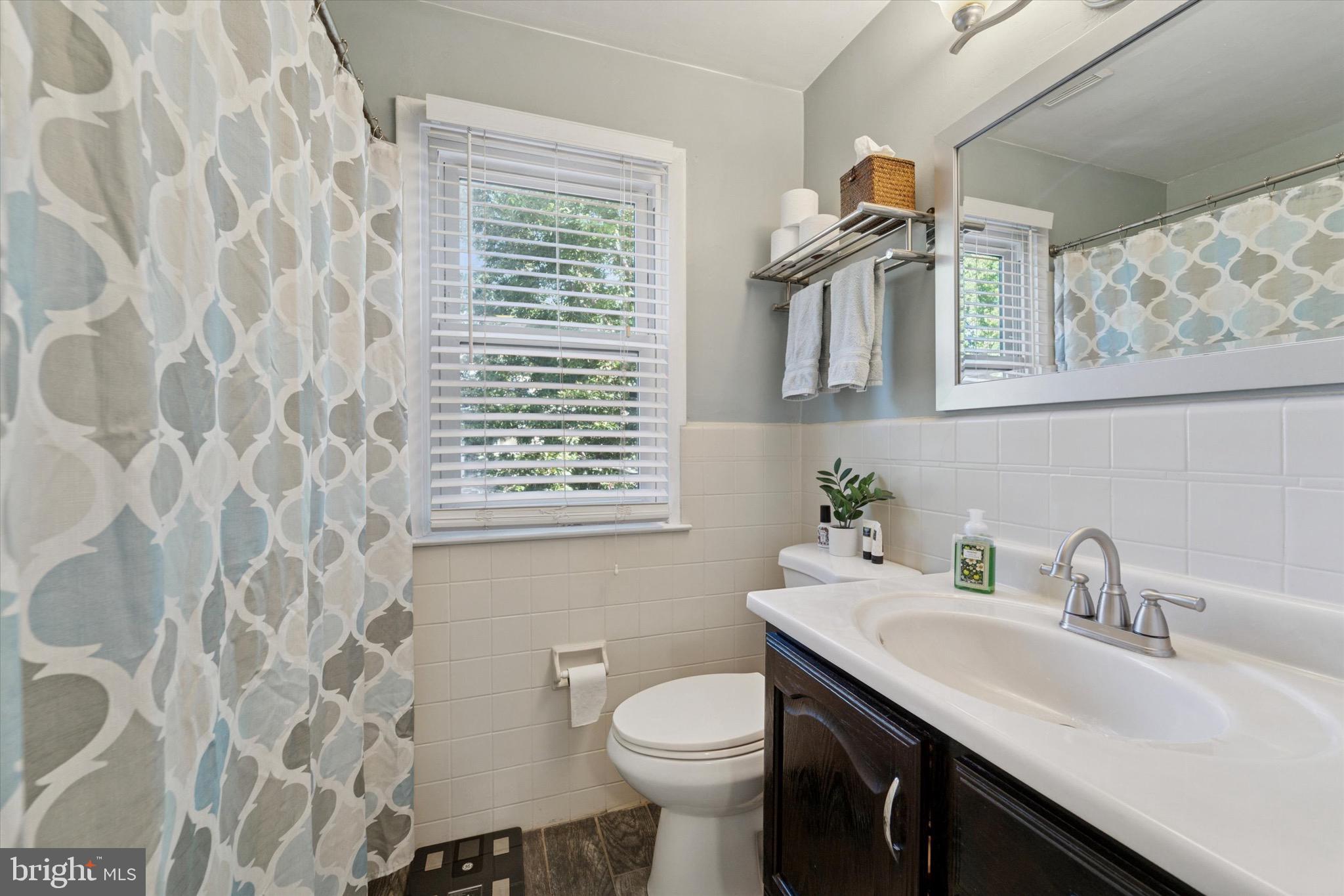 720 Swarthmorewood Lane Swarthmore, PA 19081 - Photo 17 of 25 a bathroom with a sink a toilet and a mirror