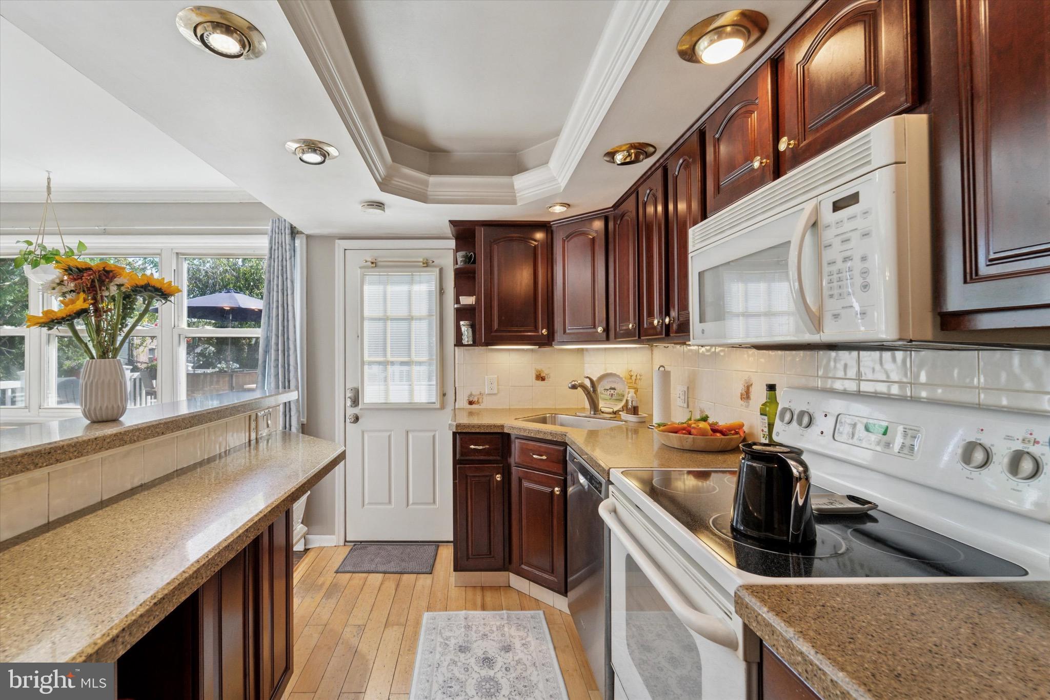720 Swarthmorewood Lane Swarthmore, PA 19081 - Photo 6 of 25 a kitchen with stainless steel appliances granite countertop a sink stove and cabinets