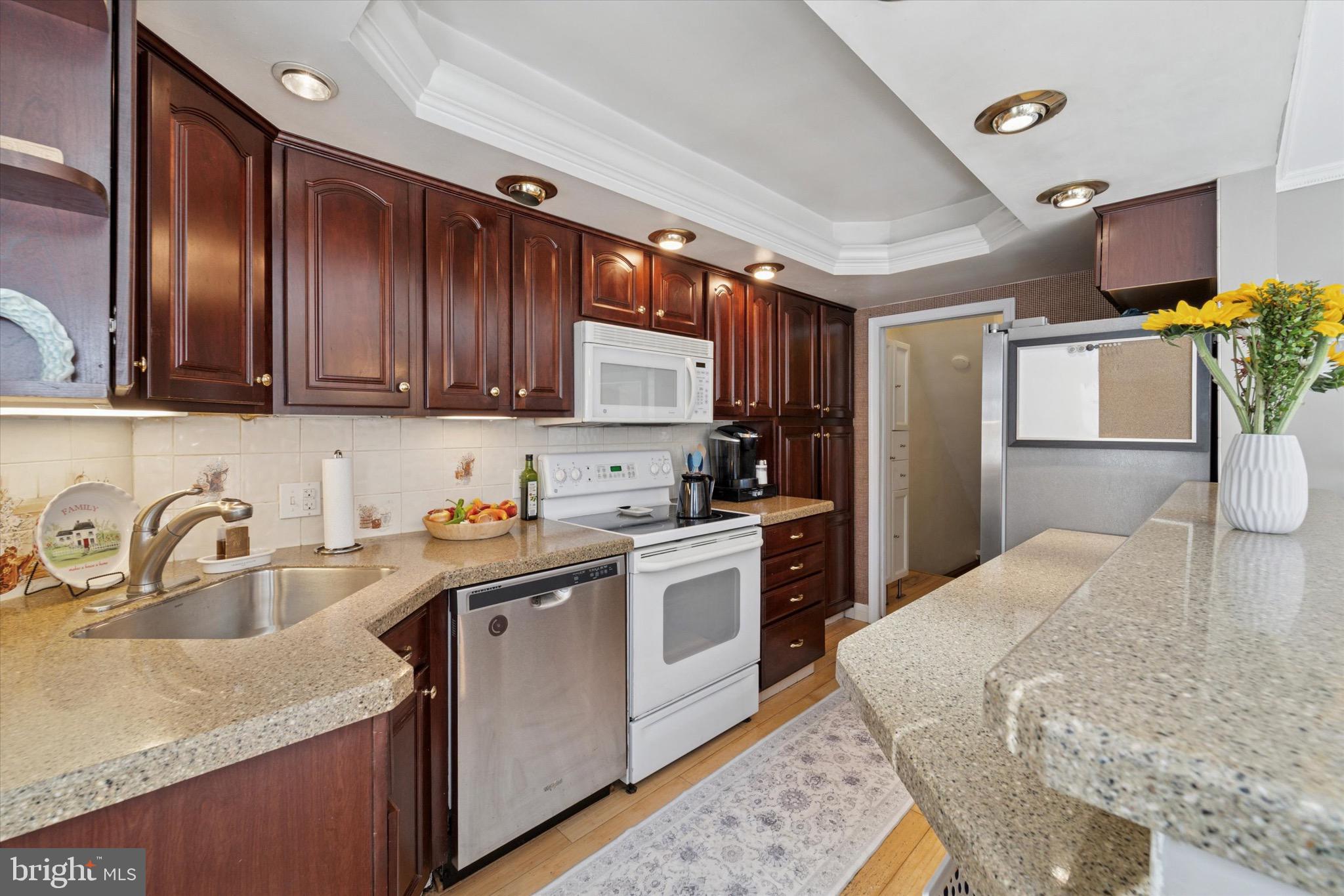720 Swarthmorewood Lane Swarthmore, PA 19081 - Photo 8 of 25 a kitchen with stainless steel appliances granite countertop a sink stove and refrigerator