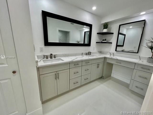 11069 Rios Road, Unit 11069 Boca Raton, FL 33498 - Photo 12 of 14 a bathroom with a double vanity sink and mirror
