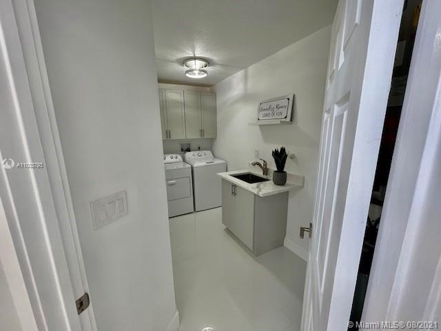 11069 Rios Road, Unit 11069 Boca Raton, FL 33498 - Photo 13 of 14 a bathroom with a sink and mirror